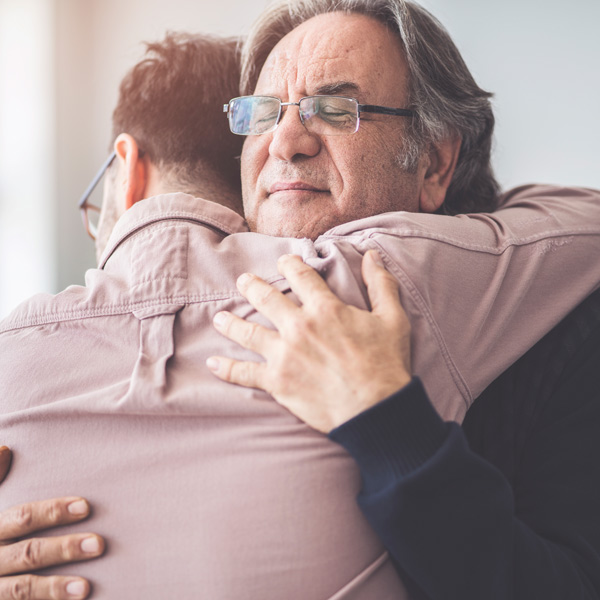 Son hugs his own father